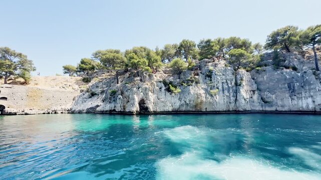 Calanque de Port Miou seen from the sea during a boat trip, showing steep limestone cliffs, deep blue Mediterranean water on the French Riviera, Cote d&rsquo;Azur, near Cassis, France.