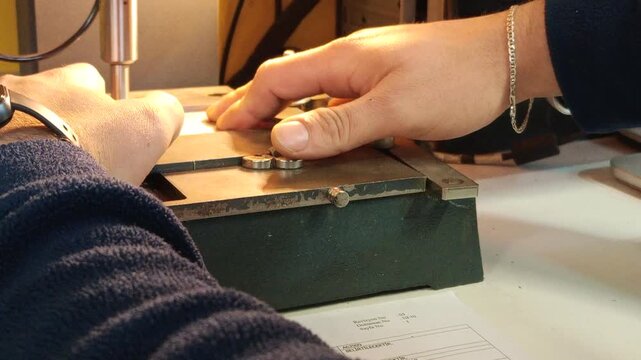 Close-up of laser marking machine engraving identification tags and industrial labels