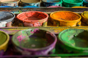 Detailed close up of colorful paint box set. Macro shot of watercolor set. Impressive bright color show concept of creativity with copy space.