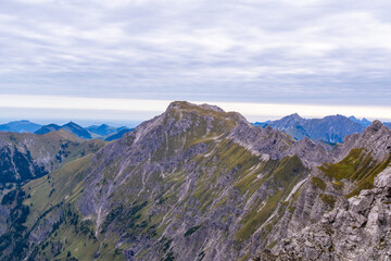 Fototapeta premium Rugged Alpine Ridge Beneath Clouded Sky