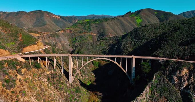 Flight over the Bixby Bridge in the striking mountains. Iconic landmark of Big Sur, California, USA.