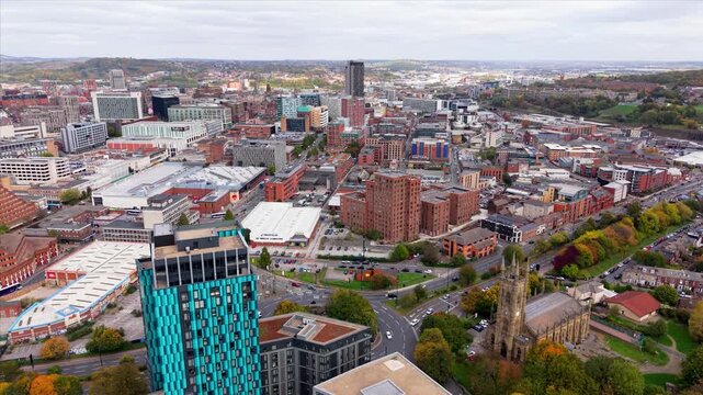 Aerial landscape drone footage above Sheffield city centre in South Yorkshire, UK with high street stores and cityscape skyline