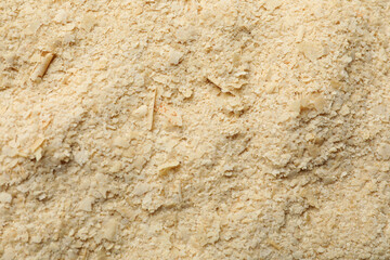 Naklejka premium Dry yeast flakes as background, top view