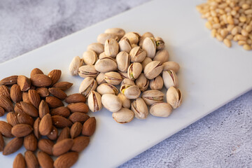 Almonds and pistachios closeup. Artistic presentation of almonds and pistachios emphasizing healthy snacking habits and natural lighting