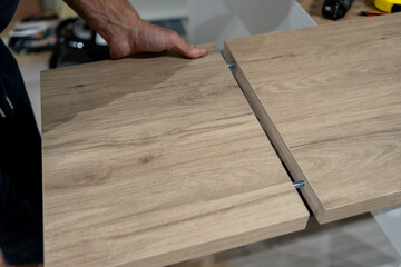 Shop scene involving walnut panel cutting process. Detailed workshop scene showing manual walnut cut with measuring and guiding tools