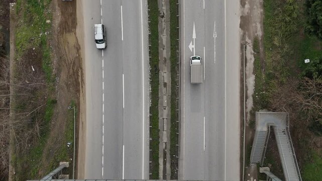 Cars driving on a highway with steady traffic flow, representing transportation, mobility, and modern urban life. The video captures movement, speed, and road infrastructure, making it suitable for tr
