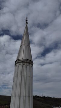 A mosque minaret featuring traditional Islamic architecture, rising elegantly against the sky. The video highlights the beauty and spiritual atmosphere of the minaret, symbolizing faith, worship, and 