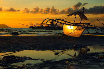 sunrise on the beach dramatic scene of an anchored boat