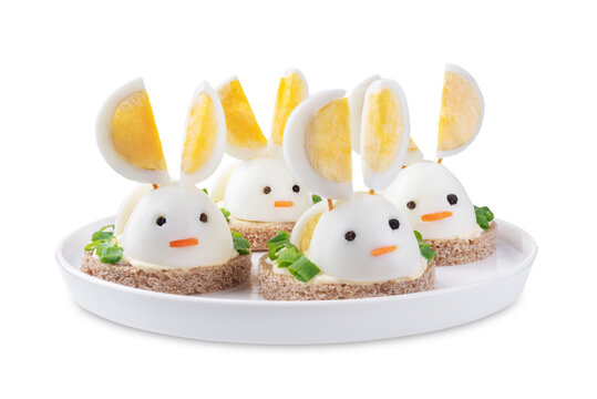 Bread with mayonnaise sauce and boiled egg in the form of rabbit in a plate on a white isolated background