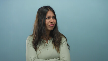 Obraz premium Young hispanic woman expressing confusion against a solid blue background with an isolated wall as she gestures with hands in frustration