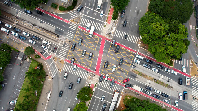 Reboucas Avenue In Sao Paulo Brazil. People Crossing Streeet In A Crosswalk Viewed From Above. Business Sky Clouds Downtown Cityscape. Outdoor Downtown Panning Wide. Sao Paulo Brazil.