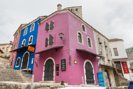 Traditional colorful stone buildings in the old town of Mostar featuring historic architecture and narrow streets.