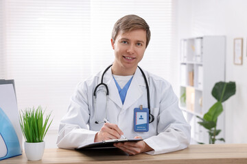 Medical assistant with clipboard at reception in clinic