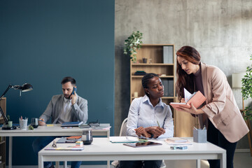Fototapeta premium Diverse business professionals collaborating in modern office environment