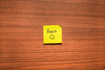 Sticky Note with Handwritten Hello and Smiley