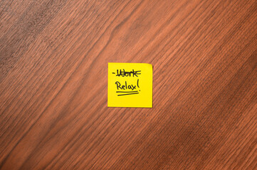 Sticky Note with Crossed-Out "Work" and Written "Relax"