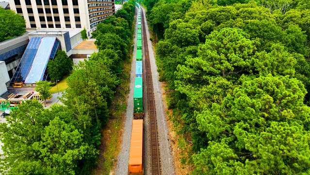 Atlanta, Georgia USA - 08 14 2024: Aerial drone photo of Lenox Station Marta and MARTA Gold Line (Metropolitan Atlanta Rapid Transit Authority). View of train running next to the Lenox Station Marta.
