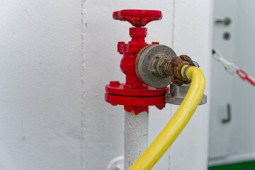 White ship water pipe with red cap and attached hose line.