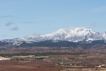 Obraz premium Snow-Capped Mountains and Wind Turbines Near Logrono, Spain