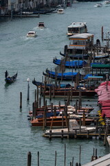 Fototapeta premium Venice canal traffic with gondolas and water bus, view from above. Venice, Italy