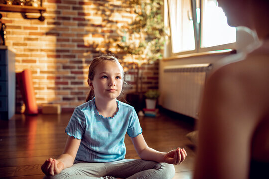 Young girl practicing meditation at home