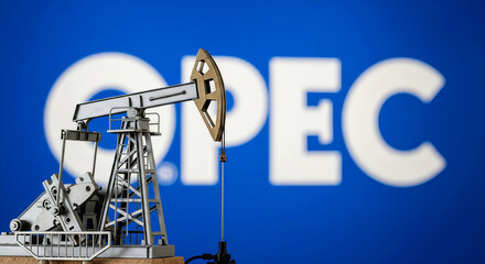 Oil pump jack in front of the OPEC logo, symbolizing global energy production and policy