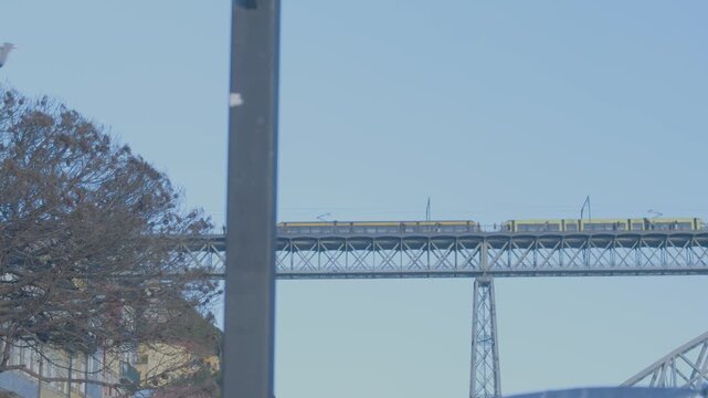 Historic street view with the iron structure of the Dom Luis I Bridge visible between buildings.
The bridge is an iconic symbol of Porto connecting the city to Vila Nova de Gaia.