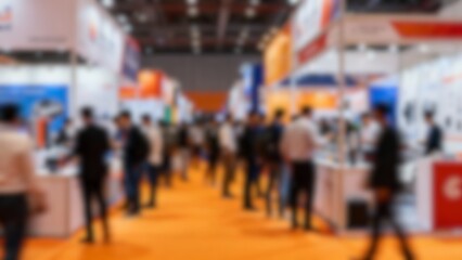Obraz premium Abstract blurred crowd at international trade fair, business expo hall with booths and displays, modern commercial exhibition, conference and marketplace background