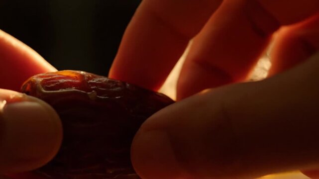 Date Fruit Macro Texture Being Opened by Hand for Iftar