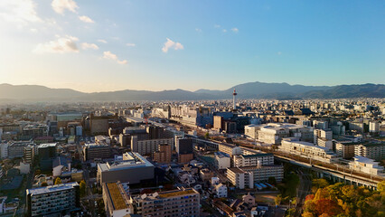 Naklejka premium Kyoto, Japan – Aerial Drone View of Kyoto Station, Shinkansen, Train Bridge, City Skyline, Kamo River, Urban Streets in Autumn, Nidec Kyoto Tower, Mountains, Houses, Apartments in Shimogyo, Higa