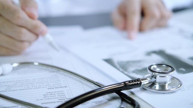 professional doctor wearing uniform taking notes in journal, physician therapist practitioner filling medical documents on clipboard patient form history and prescription, talking with patient