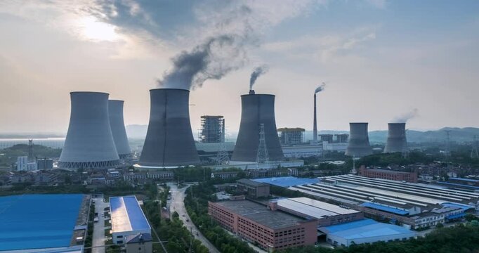 Aerial time-lapse of a large coal-fired power plant at dusk,  traditional grid stabilizer to a modern, flexible partner in the new energy system.