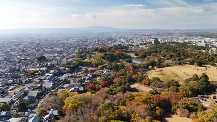 Obraz premium Nara, Japan: Aerial Footage of Nara Park in Autumn, Tōdai-ji Temple Roofline, Cityscape in Distance, Mount Wakakusa, Kasuga Primeval Forest, Scenic Nature and Cultural Heritage