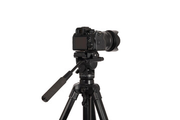 Modern camera with tripod isolated on white background. Photographer's equipment