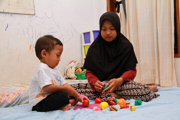 older sister is playing with her younger sister