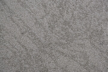 Fototapeta premium Close-up texture of a grey carpet with a dense, looped pile and subtle variations in shade