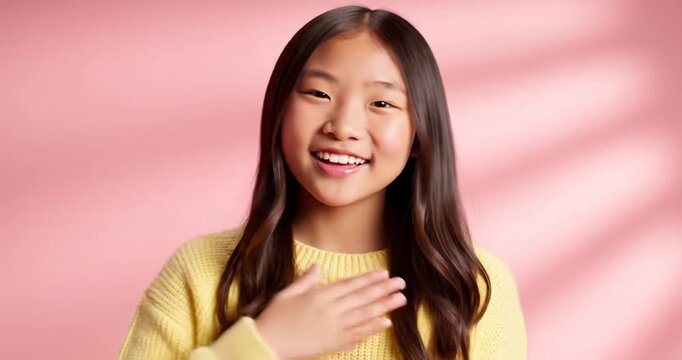 Smiling Asian woman greeting hello.