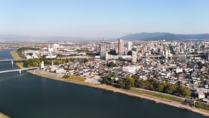 Obraz premium Kurume, Fukuoka, Kyushu Island, Japan: Aerial View of Nagatoishi Bridge, Chikugo River, Train Bridge, Shinkansen Line, Railway, Farmland, City Skyline, Houses, Estates and Residential District
