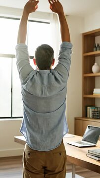 Stretching Arms Overhead for Back Relief in Home Office