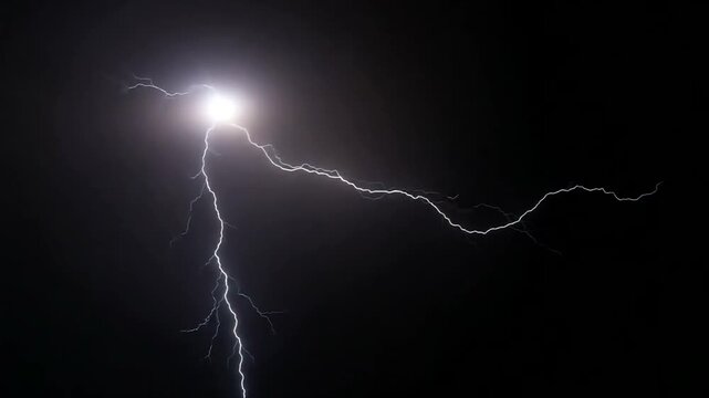 Bright Lightning Bolt Illuminates Dark Night Sky During Storm.