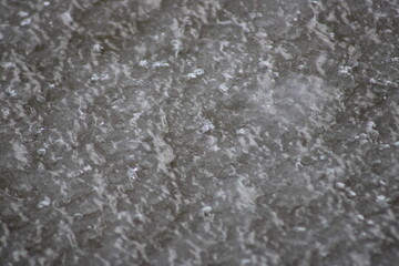 Obraz premium Abstract close-up texture of frozen ice surface with natural crystalline patterns, subtle highlights, and winter frost detail.