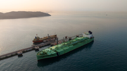 Aerial view LPG tanker ship at oil and gas terminal platform, Liquefied Petroleum Gas tanker ship industrial oil gas terminal tanker ship, LPG tanker ship loading and unloading petrochemical industry.
