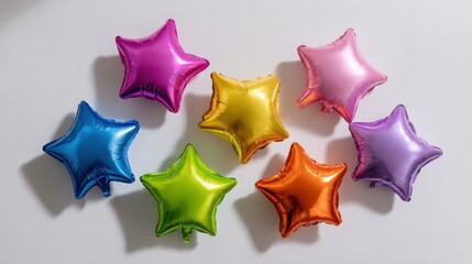 Obraz premium Shiny metallic star-shaped foil balloons in vibrant colors arranged playfully