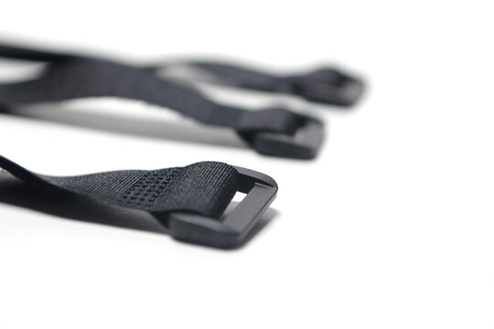 set of black nylon utility straps, commonly used for securing gear, organizing cables, or fastening items to backpacks and outdoor equipment. Each strap features a durable