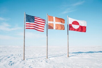 Fototapeta premium National flags of USA denmark and greenland flying side by side on wooden poles in snowy landscape
