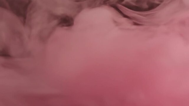 An abstract image of green smoke. It has a cloudy and blurry texture with a dark background