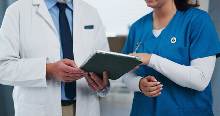 Hands, doctors and tablet for planning at clinic with team review, checklist or insight for medical...