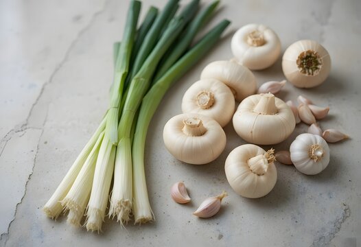 Fresh green onions and unique solo garlic bulbs alongside cloves resting on a rustic surface. baby bella mushroom