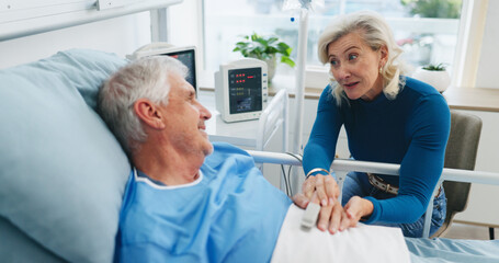 Obraz premium Old couple, advice and holding hands by hospital bed with support, kindness or empathy for recovery. Married, elderly people and love in medical clinic with compassion, conversation or health update.