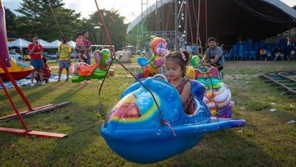 Little girl enjoy outdoor amusement city park festival © themorningglory